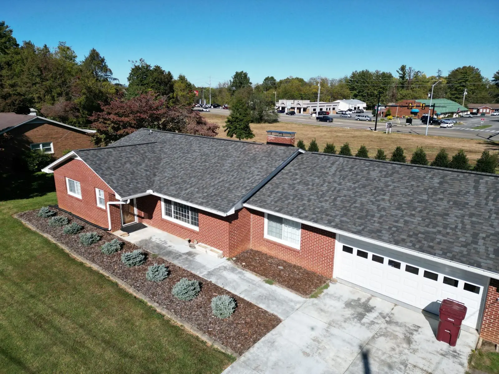 Drone view of a dark grey shingle roof replacement in Elizabethton