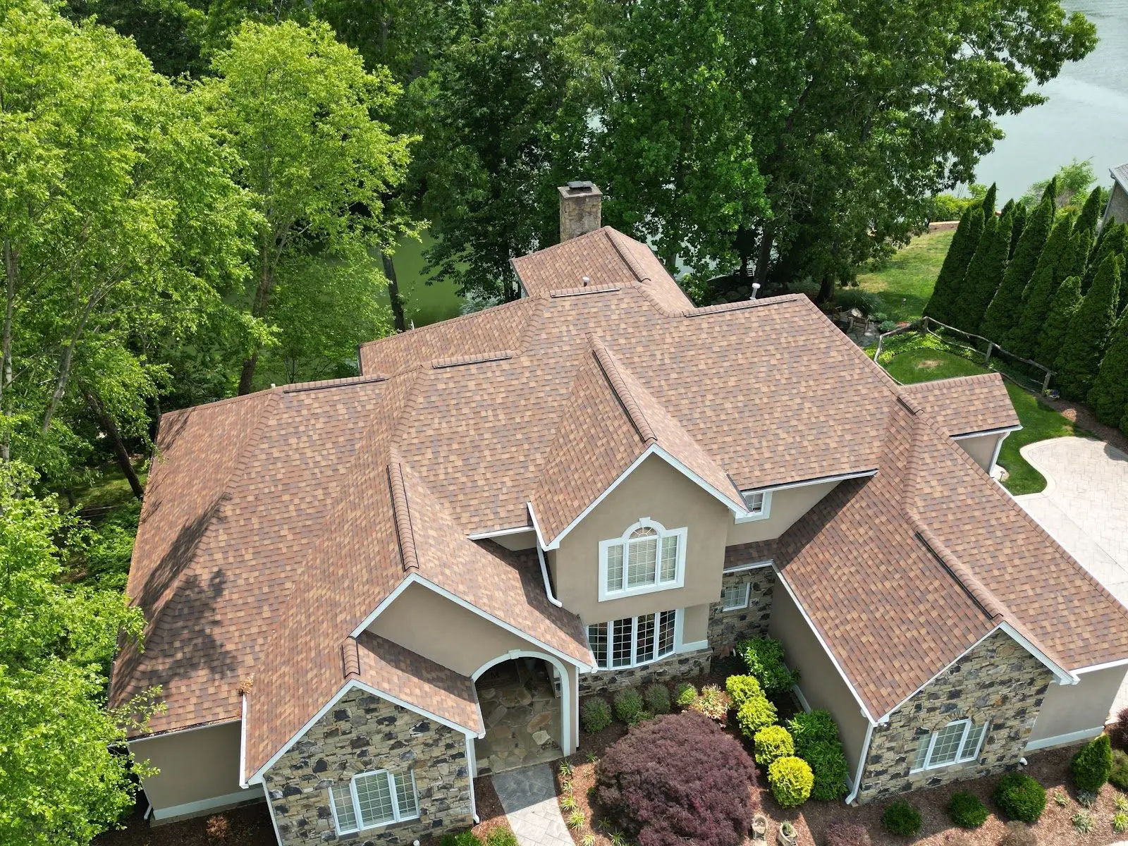 Finished brown architectural shingle roof on a lakeside luxury home in Northeast Tennessee
